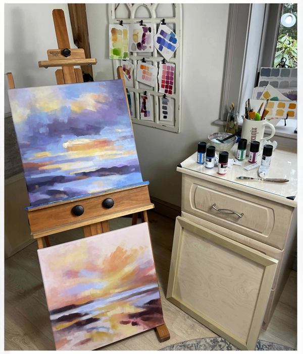Sunset paintings on easel in art studio
