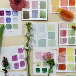 Watercolor paint swatches with assorted flowers on display
