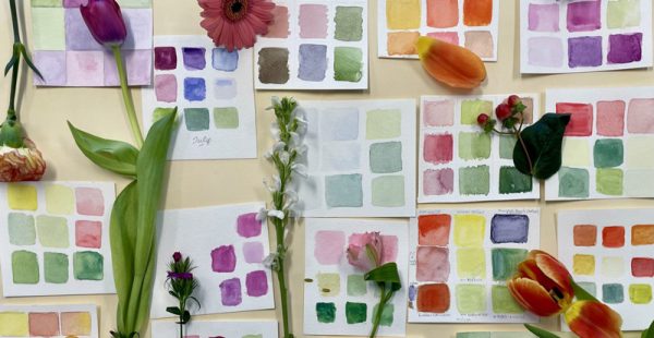Watercolor paint swatches with assorted flowers on display