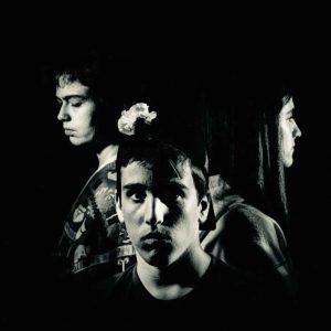 Three people in dramatic black and white lighting
